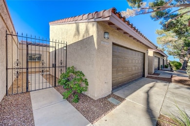 View of side of property with stucco siding, a gat