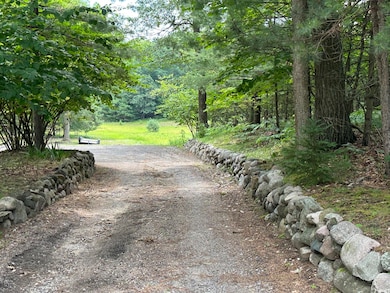 Inviting rock lined driveway
