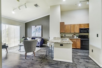 Kitchen featuring kitchen peninsula, a kitchen bre
