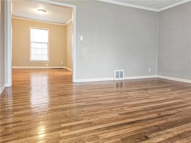 View of living room and dining room from front door. 