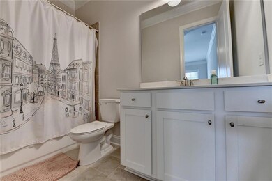 Full bath with vanity, tile patterned floors, and shower / bath combo with shower curtain