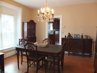 Formal dining room with a high ceiling.