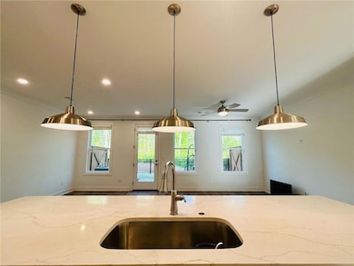 Kitchen with open floor plan, decorative light fix