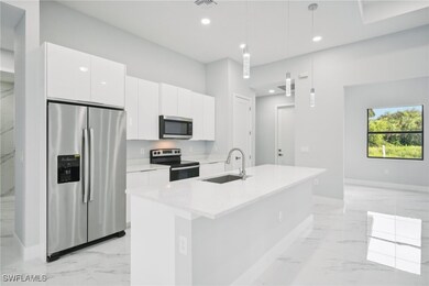 Kitchen with a center island with sink, marble fin