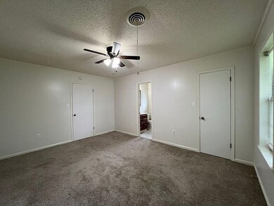 Unfurnished room featuring dark colored carpet, a 