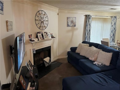 Living room featuring a textured ceiling, ornament
