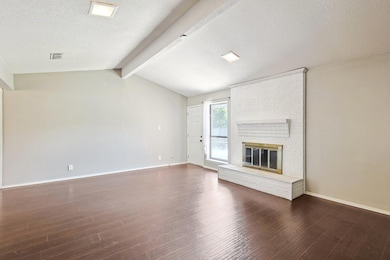 Unfurnished living room with lofted ceiling with b