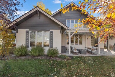 Back of house featuring a yard, a patio, stucco siding, and outdoor lounge area