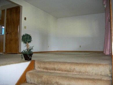 Wide stairs going up to living room