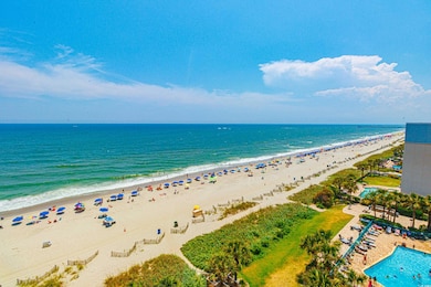Drone / aerial view with a water view and a beach 