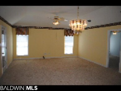 Combination Living Room and Dining Room with carpet, ceiling fan and elegant light fixture.
