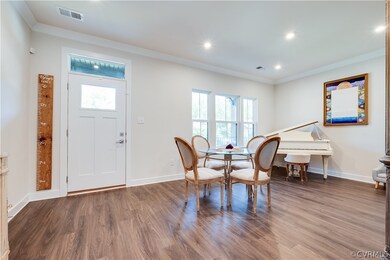 Dining room featuring crown molding and dark wood-