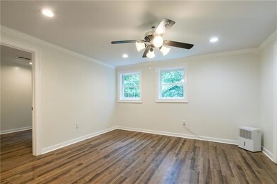 Unfurnished room featuring dark wood-type flooring, ornamental molding, recessed lighting, and ceiling fan