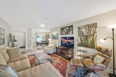 Family room facing dining area and front door entr