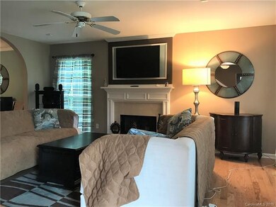 Large Living Room with New Pre-Finished Wood Flooring, Gas Fireplace and a Wall Mounted Television with Surround Sound.
