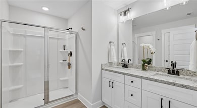Full bath featuring a shower stall, wood finished 