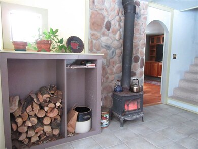 Cozy area in the kitchen with woodstove.