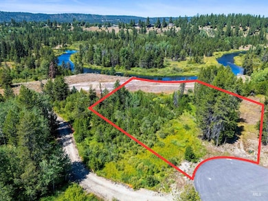 Aerial view of property's location with property parcel outlined and a large body of water
