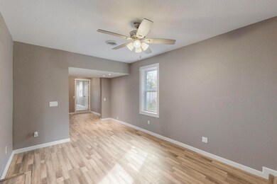 Empty room with baseboards, ceiling fan, visible v