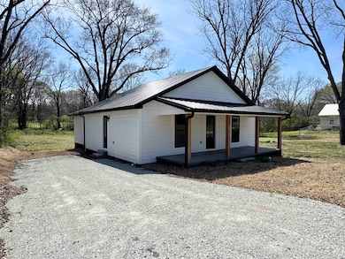 View of front of property featuring metal roof, gr