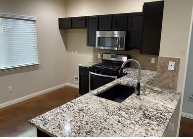 Kitchen with a sink, stainless steel appliances, 