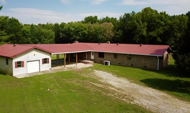 Parking is no problem with this detached workshop/garage and over-sized covered carport.