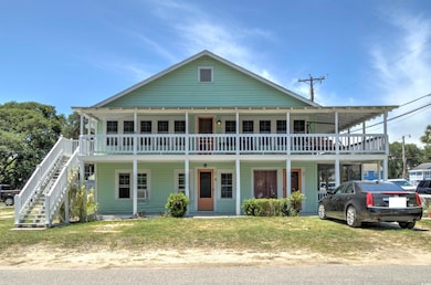 View of front of house featuring stairway and covered porch