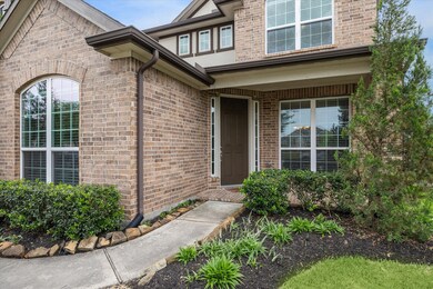 A charming covered front porch welcomes you inside.  Notice the gutters along the front of the home.