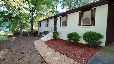 View of property exterior with brick siding and crawl space