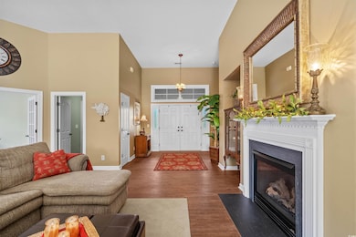 Living area with baseboards, a high ceiling, a fir