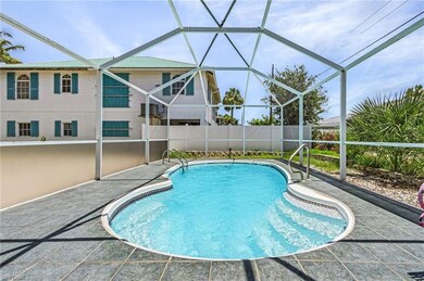 View of pool with glass enclosure and a patio