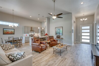 Living room featuring a chandelier, light wood-ty