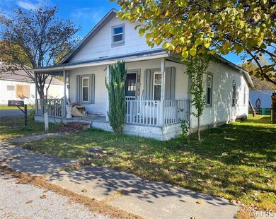 Bungalow-style home with covered porch and a front lawn