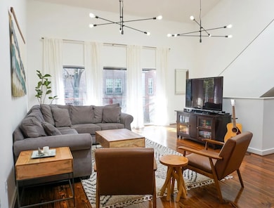 Vaulted Ceiling, wood floors, Juliette Balcony, tons of natural lighting. This Open Living Space is breathtaking and cozy.