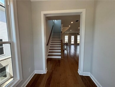 A welcoming foyer with a large window and hard surface flooring to greet you and your guests as you enter the home.  Photo not of actual home, but previously built TPG home. For representation purposes only.