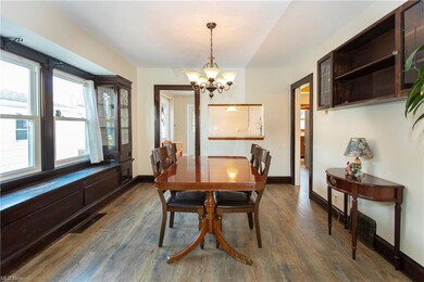 Beautiful formal dining room with built-in cabinets, window seat & and new flooring