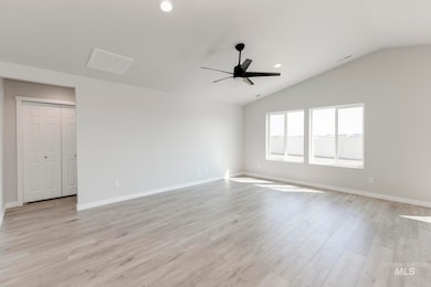 Unfurnished room with light wood finished floors, vaulted ceiling, recessed lighting, and a ceiling fan