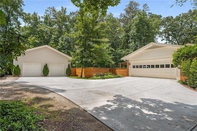 View of side of property with a garage and an outbuilding