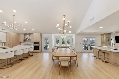 Dining area featuring a chandelier, light wood fin