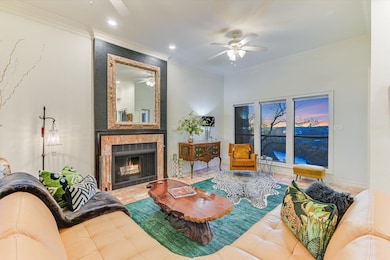 Living room featuring a tiled fireplace, a ceilin
