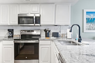 Kitchen with white cabinetry, stainless steel appl