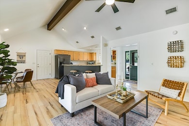 Living room featuring beam ceiling, light wood finished floors, high vaulted ceiling, recessed lighting, and a ceiling fan