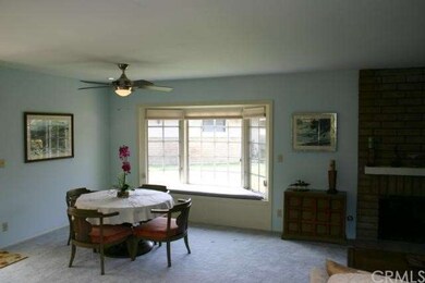 Dining area off the living room has a ceiling fan/