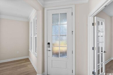 Doorway to outside featuring hardwood / wood-style