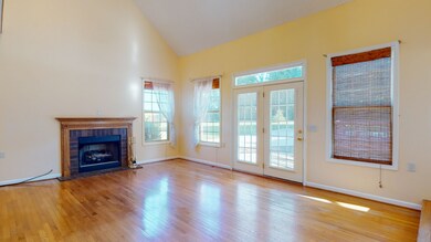 Spacious living area with fireplace and hardwood floors. The French doors open to the large patio. 
