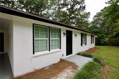 View of exterior entry featuring brick siding
