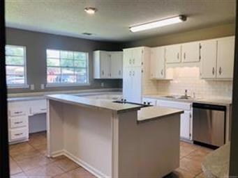 Huge kitchen has new countertops, subway tile back