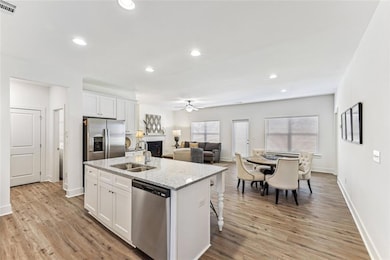 Kitchen with light wood-type flooring, white cabin