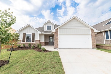 Craftsman house with an attached garage, driveway, brick siding, a front lawn, and roof with shingles