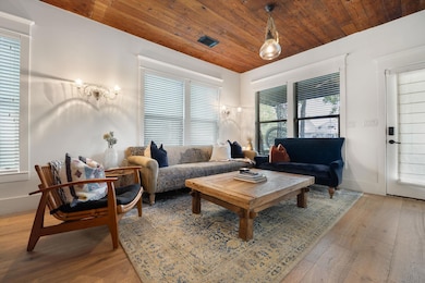 Living room with wooden ceiling, light wood finis